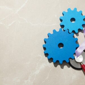 Wooden gears with stethoscope, epilepsy day concept