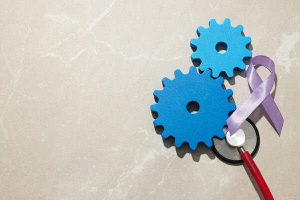 Wooden gears with stethoscope, epilepsy day concept