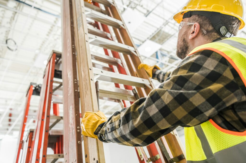 Worker Taking a Ladder To Work at Heights