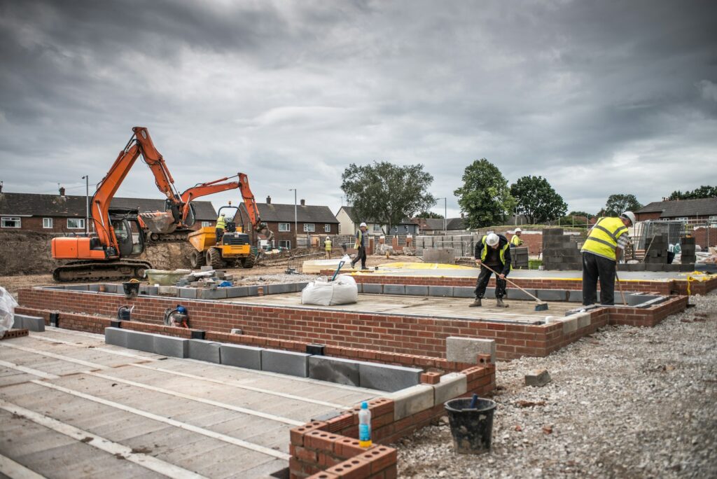 Workers laying bricks on construction site